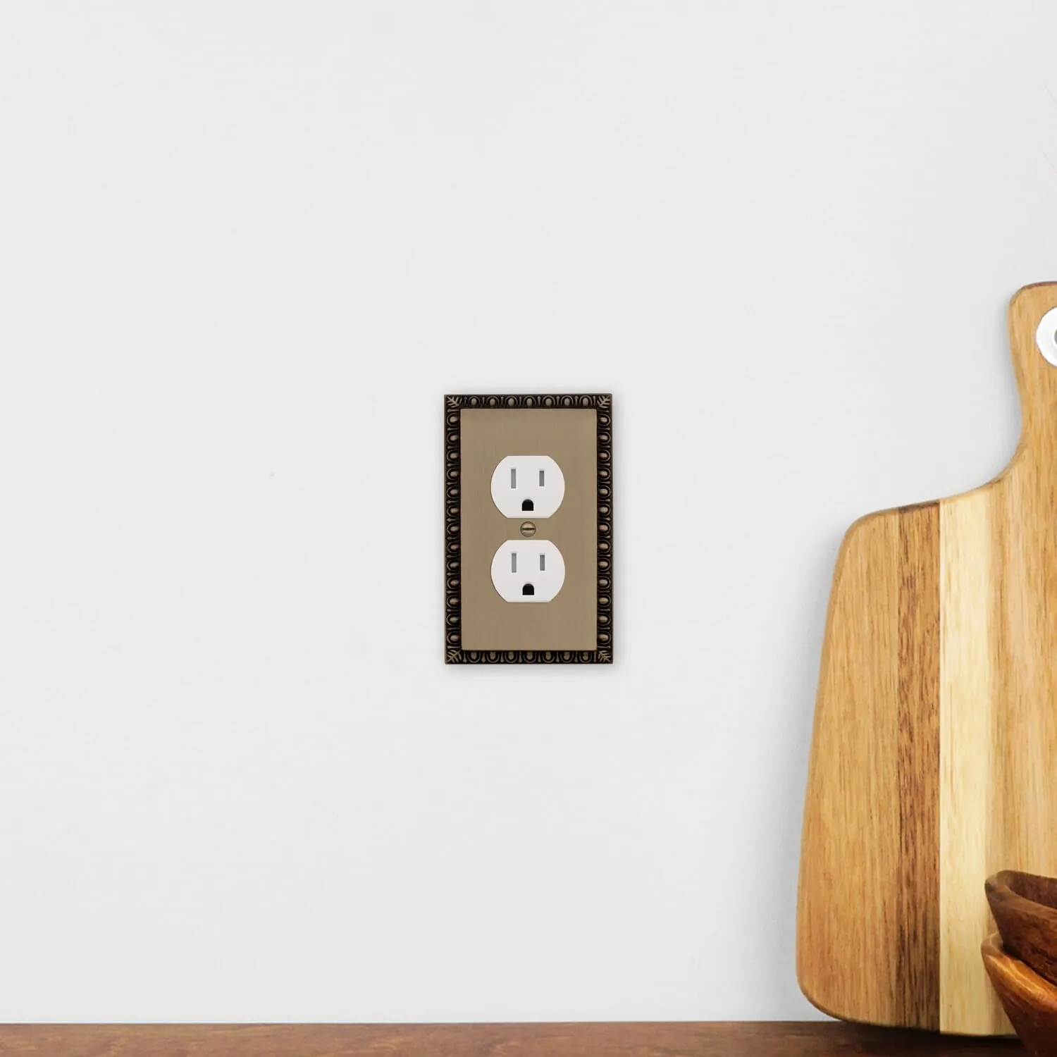 Egg & Dart Switch Plate with Outlet in Antique Brass