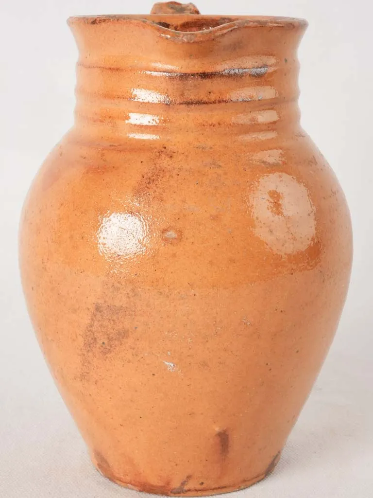 Ocher pitcher w/ ribbing at top 8"