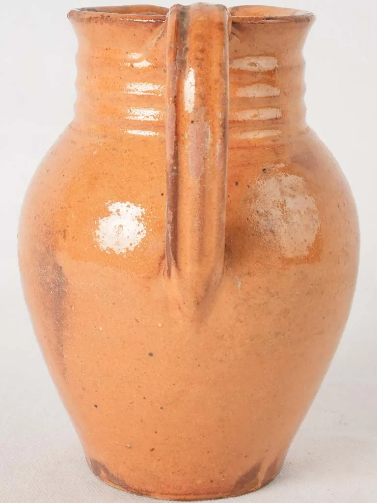 Ocher pitcher w/ ribbing at top 8"