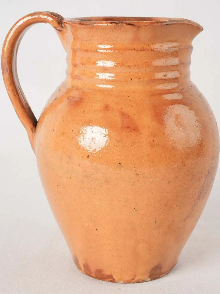 Ocher pitcher w/ ribbing at top 8"