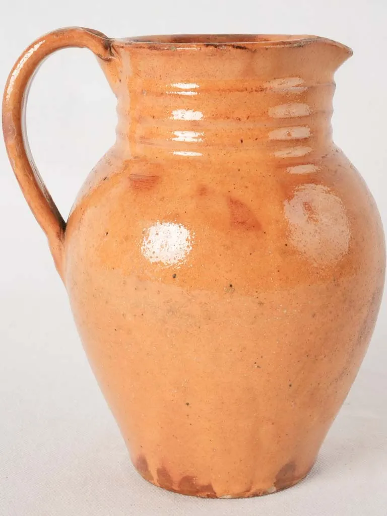 Ocher pitcher w/ ribbing at top 8"