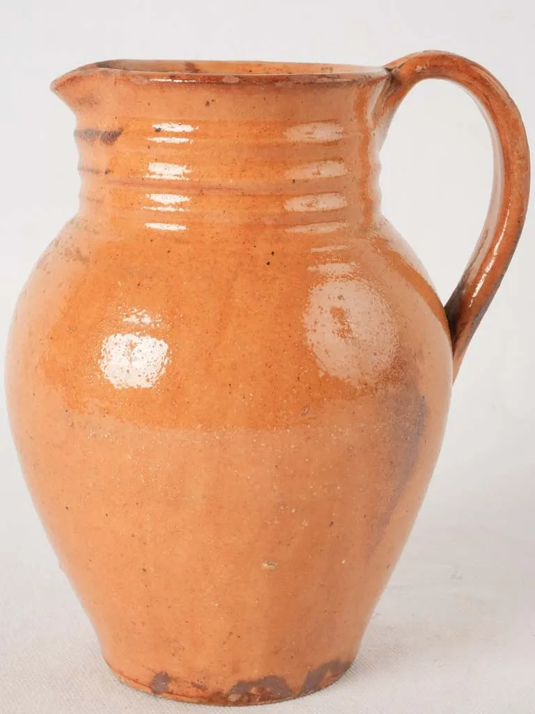 Ocher pitcher w/ ribbing at top 8"
